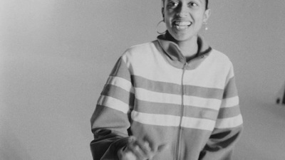 a black and white photo of a woman smiling