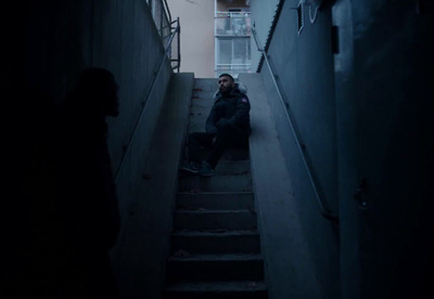 a man is sitting on the stairs in the dark