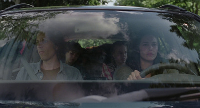 a group of people sitting in the passenger seat of a car