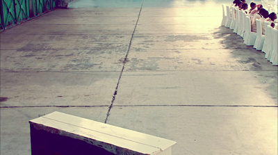 a row of white chairs sitting on top of a cement floor