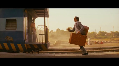 a man in a suit is carrying a suitcase