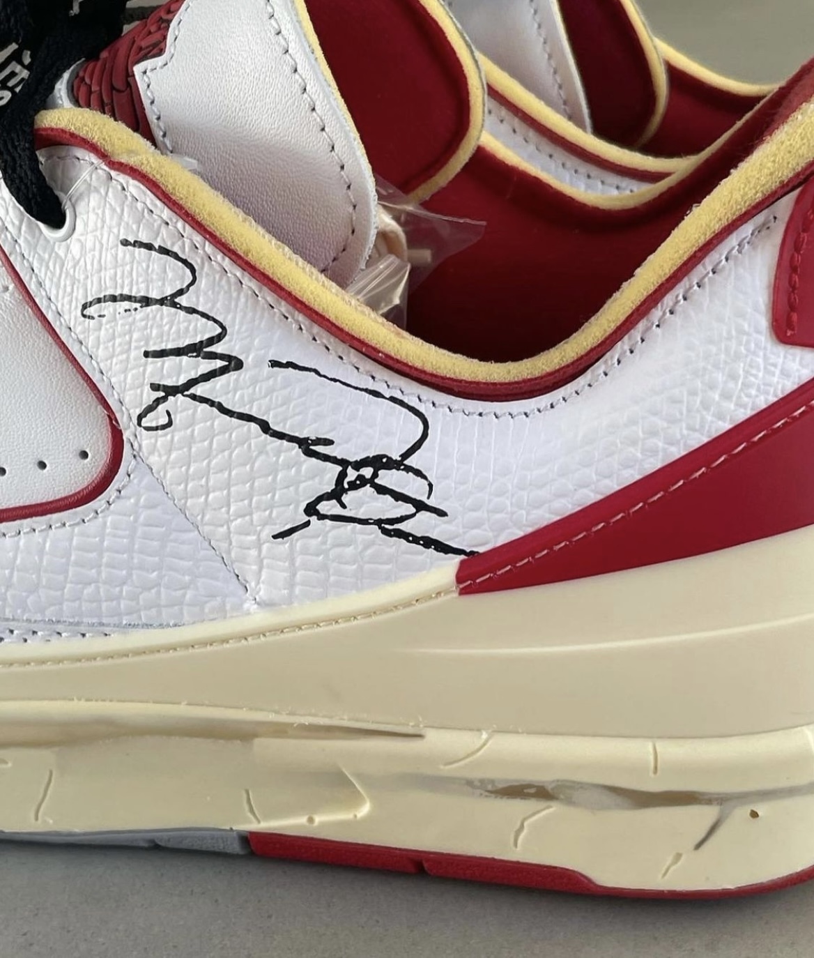 a pair of sneakers with autographs on them