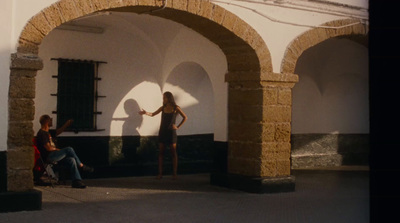 a woman standing in front of a white building