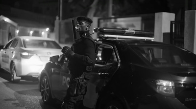 a police officer standing next to a parked car