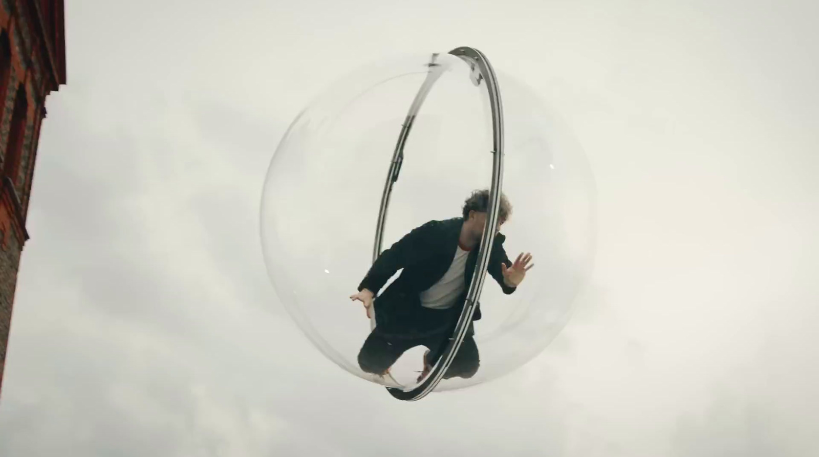 a man in a suit is suspended in a bubble