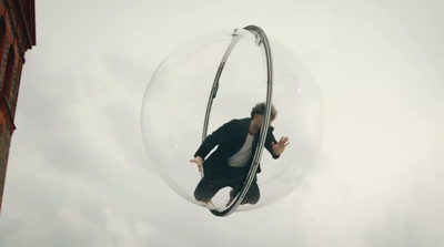 a man in a suit is suspended in a bubble