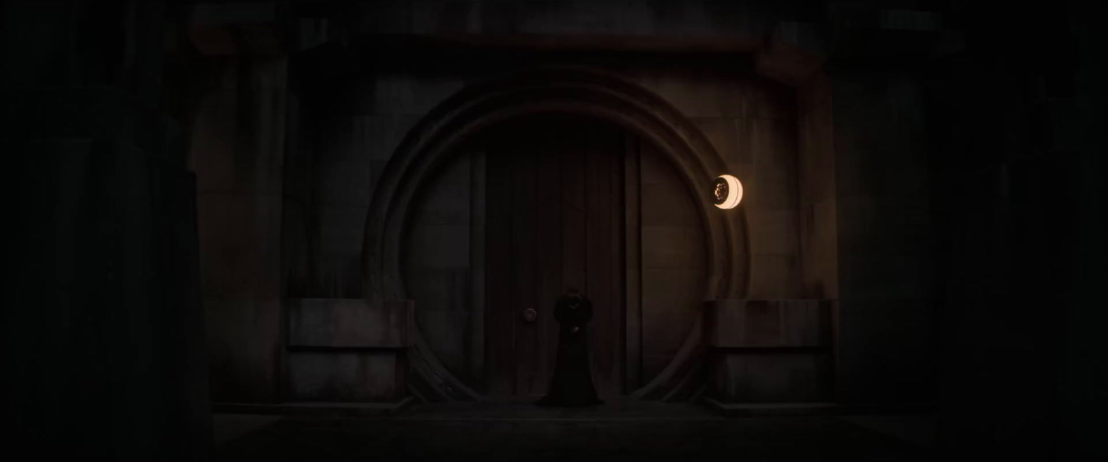 a person standing in a doorway at night