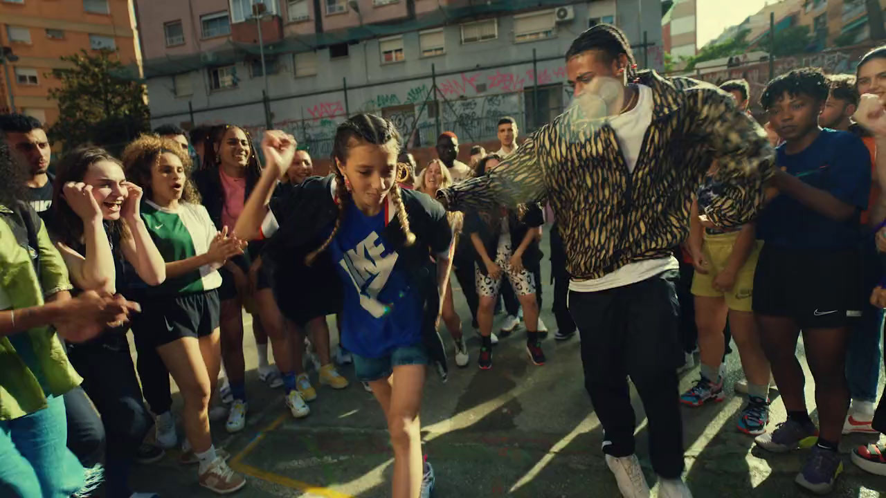 a man with a beard is dancing in front of a group of people