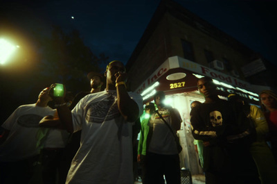 a group of people standing in front of a building at night