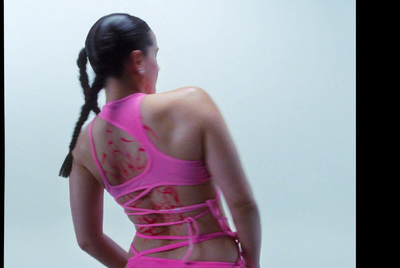 a woman in a pink swimsuit with her back to the camera