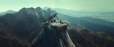 a group of people sitting on top of a mountain