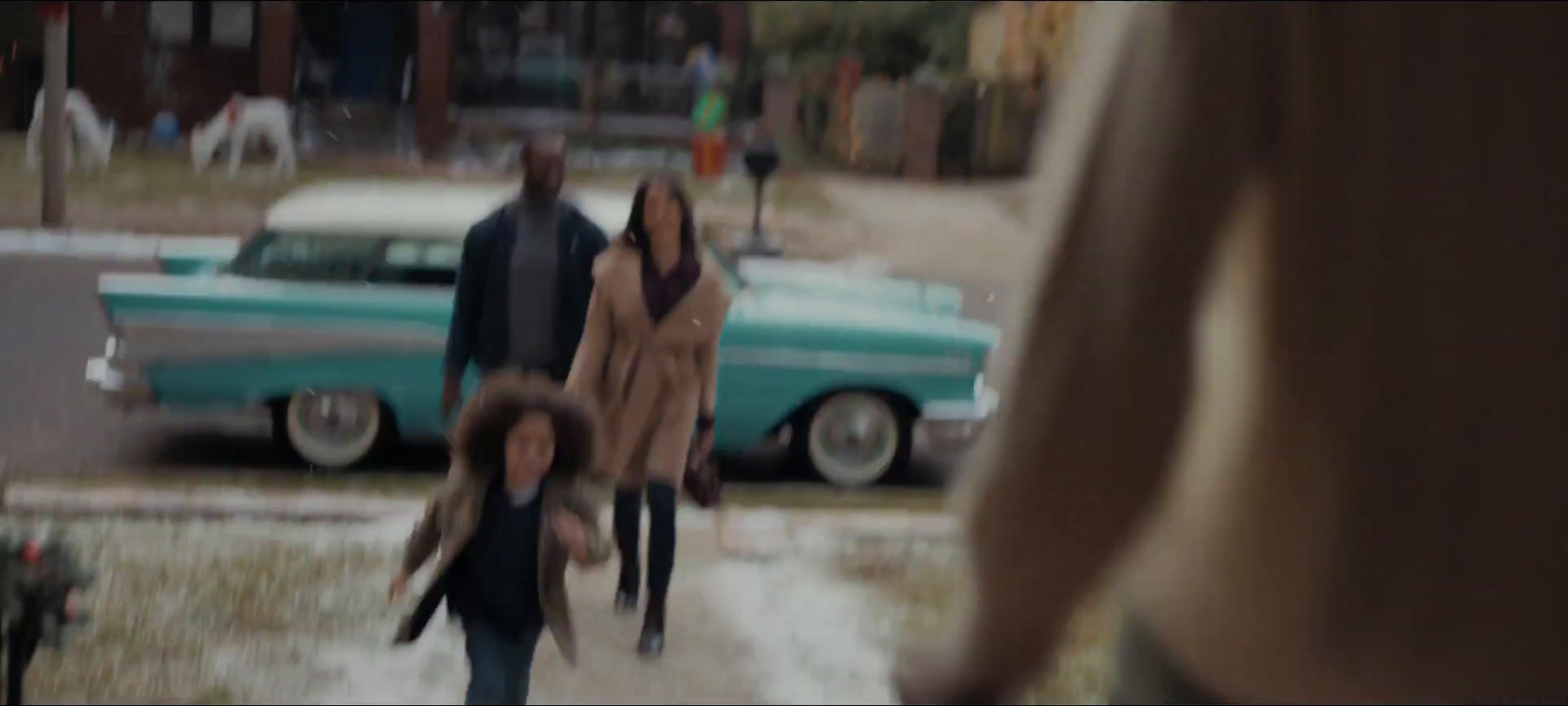 a group of people walking down a street next to a car