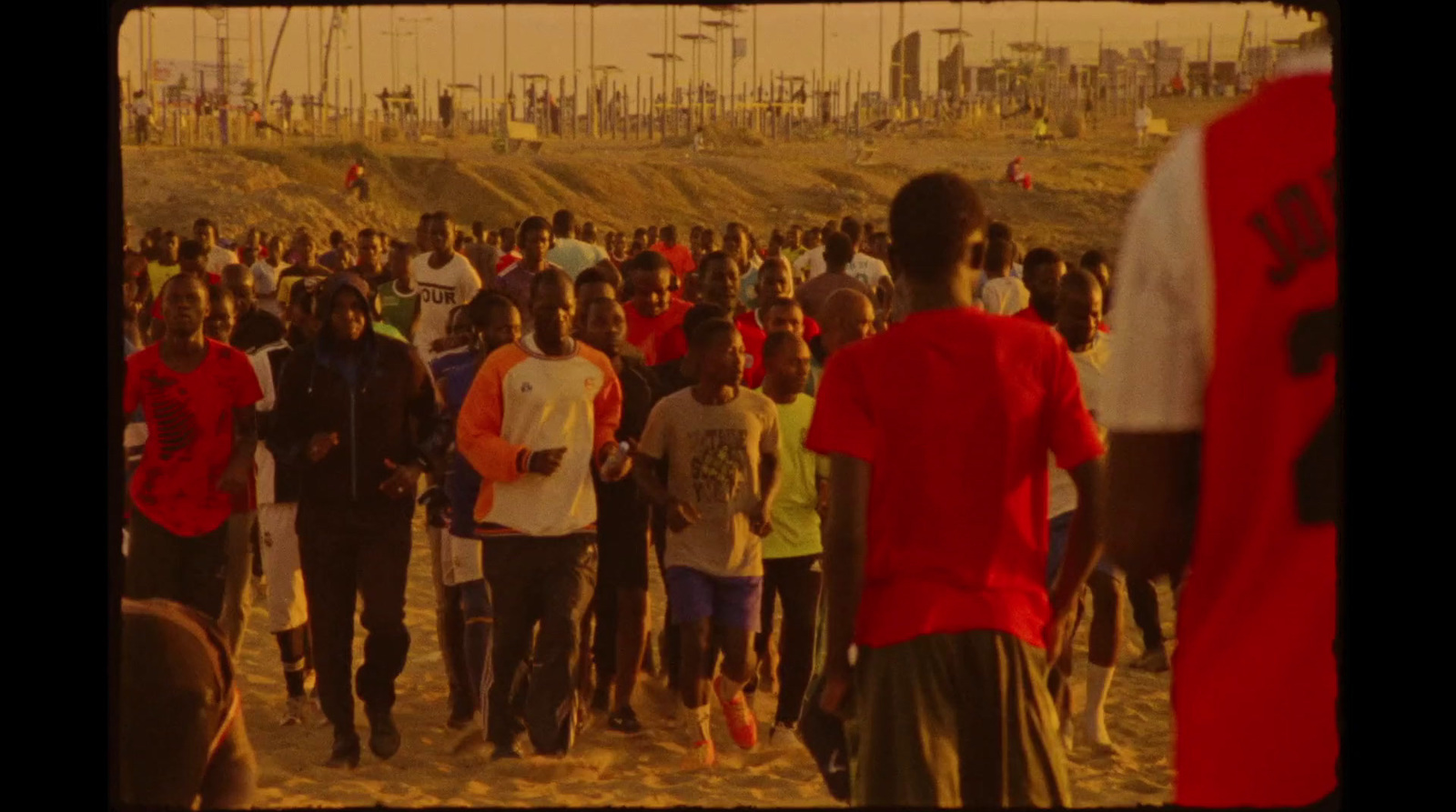 a large group of people walking on a beach