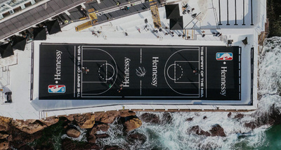 an aerial view of a basketball court next to the ocean