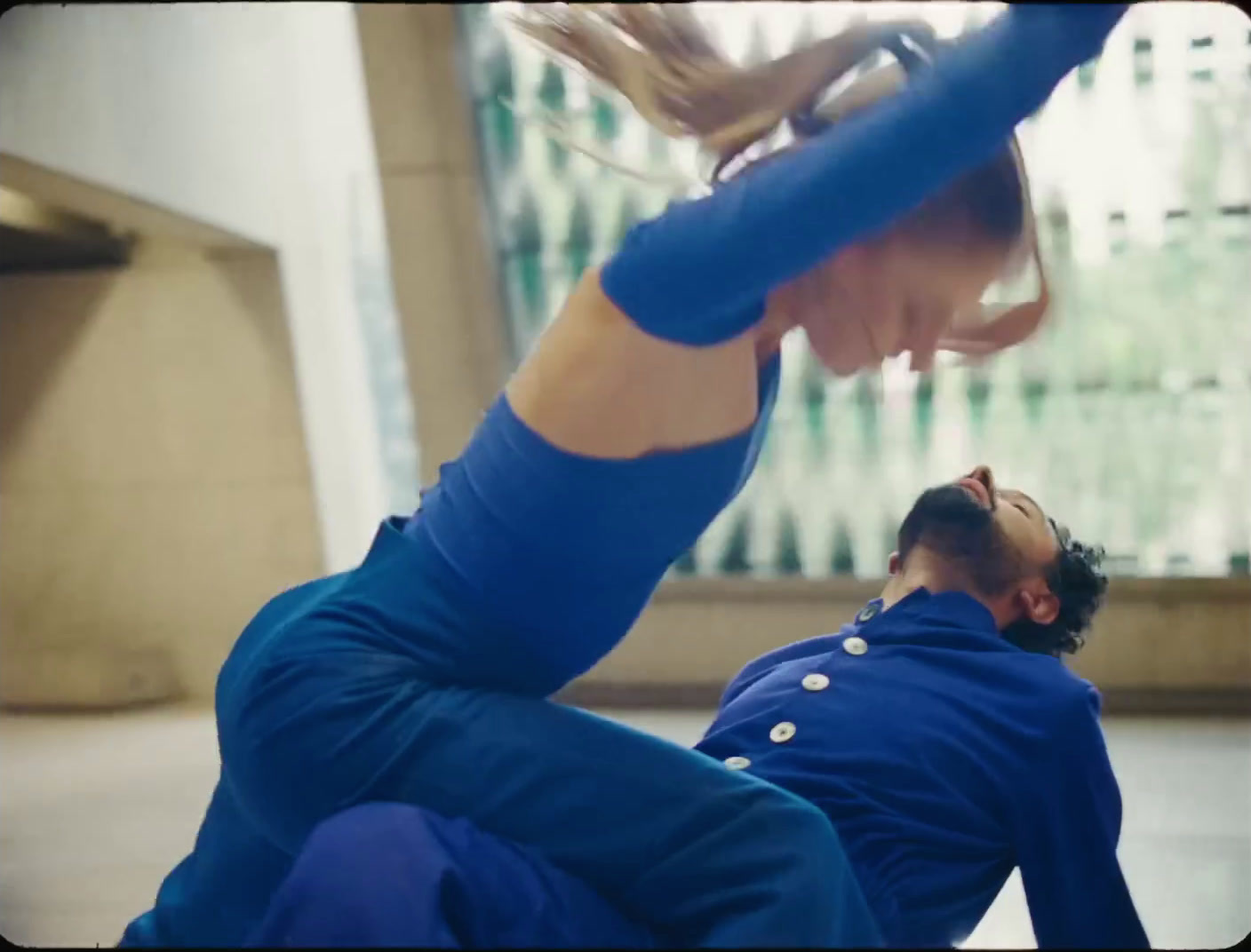 a man and a woman doing a handstand on the floor