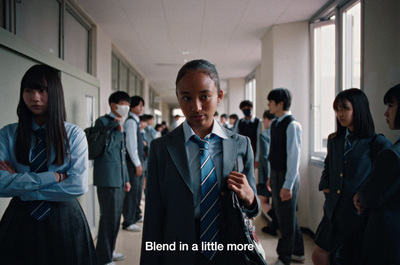 a group of young people standing in a hallway