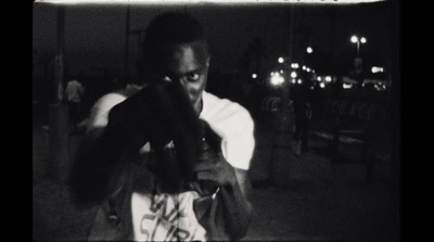 a black and white photo of a person holding a glove