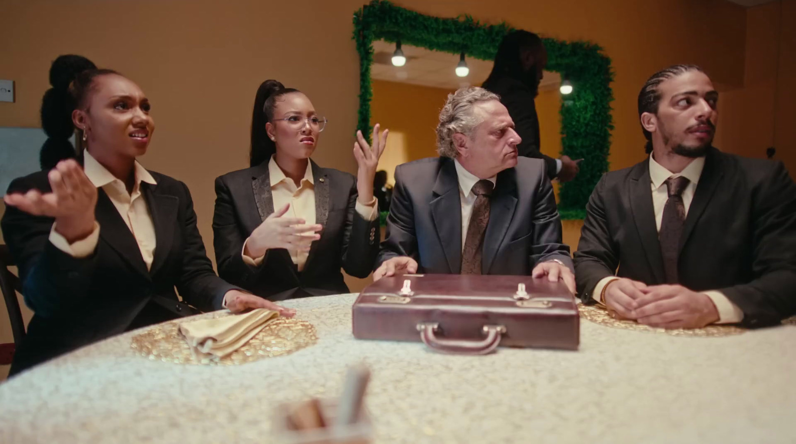 a group of business people sitting around a table