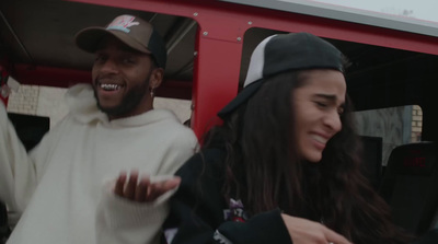 a man and a woman sitting in the back of a bus