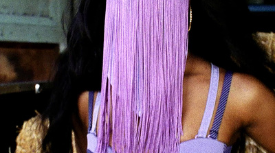 a woman with long purple hair and a purple dress