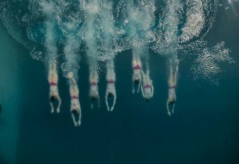 a group of people swimming in the ocean