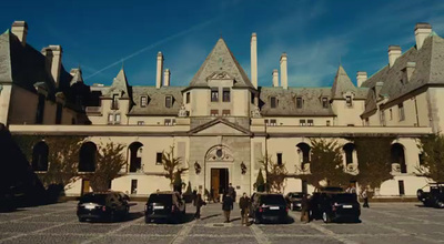 a large building with cars parked in front of it