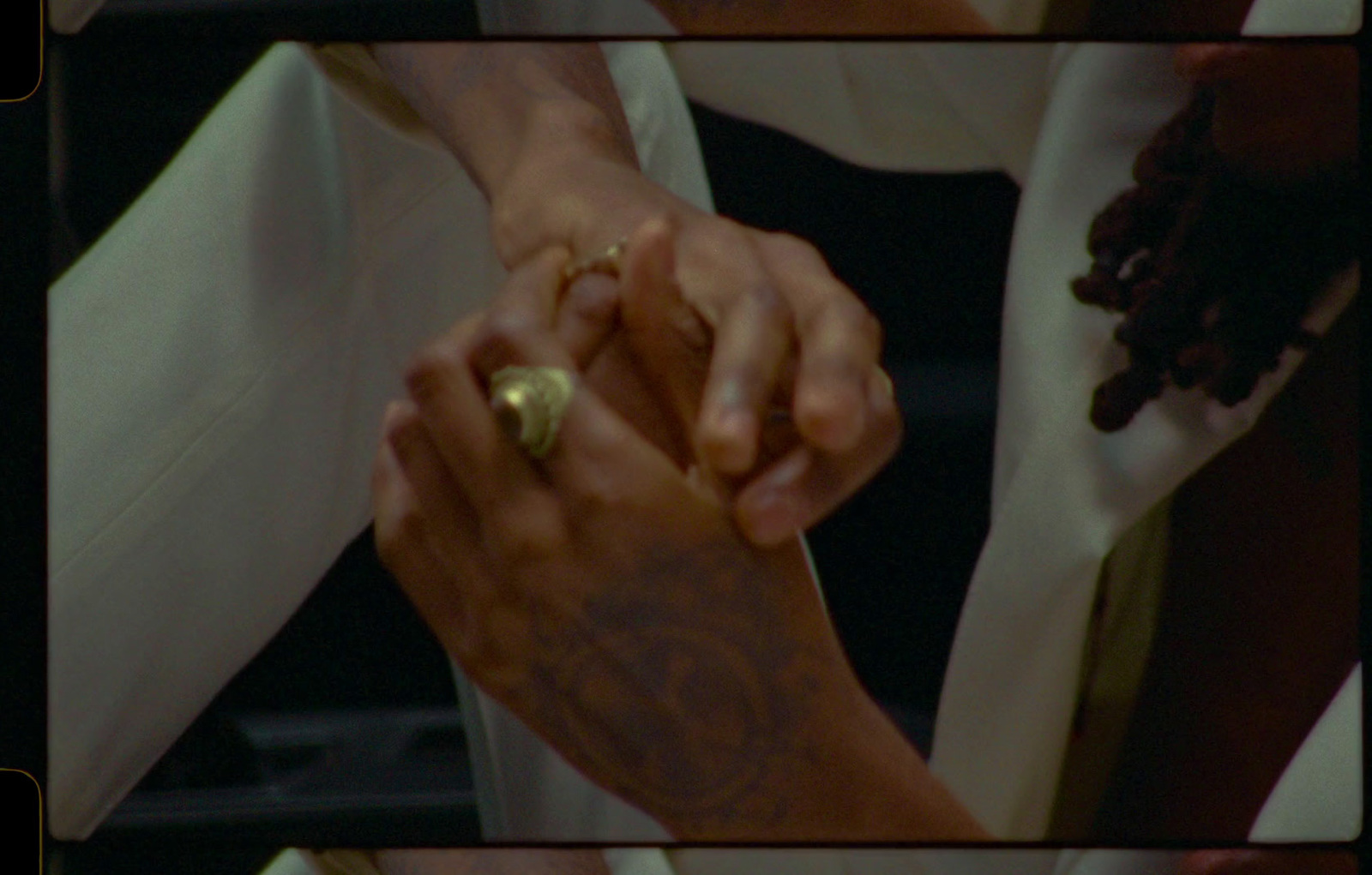 a close up of two people holding hands