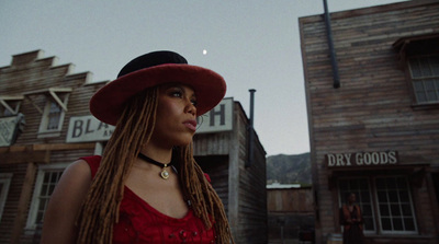 a woman wearing a red dress and a red hat