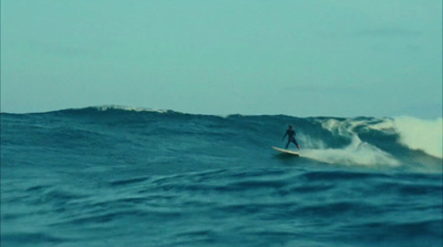 a man riding a wave on top of a surfboard