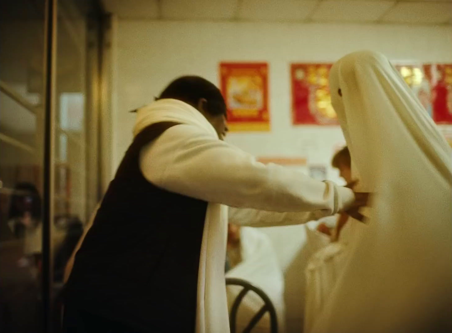 a man in a priest's robe is putting on a veil