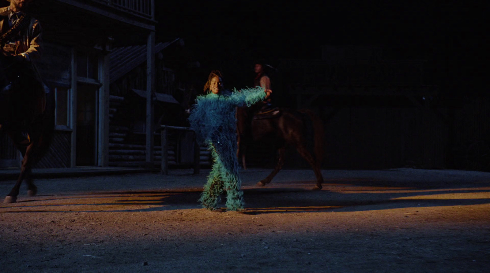 a woman in a feathered dress riding a horse