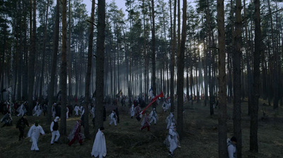 a group of people walking through a forest