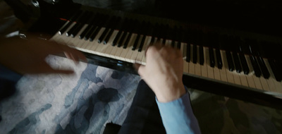 a person playing a piano in the dark