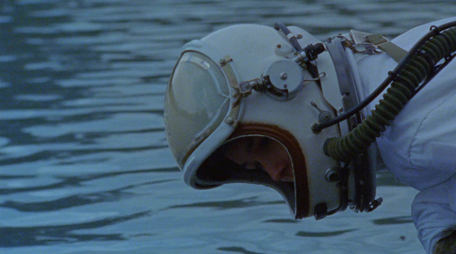 a diving helmet hanging from the side of a boat