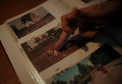 a hand is pointing at a picture in a book