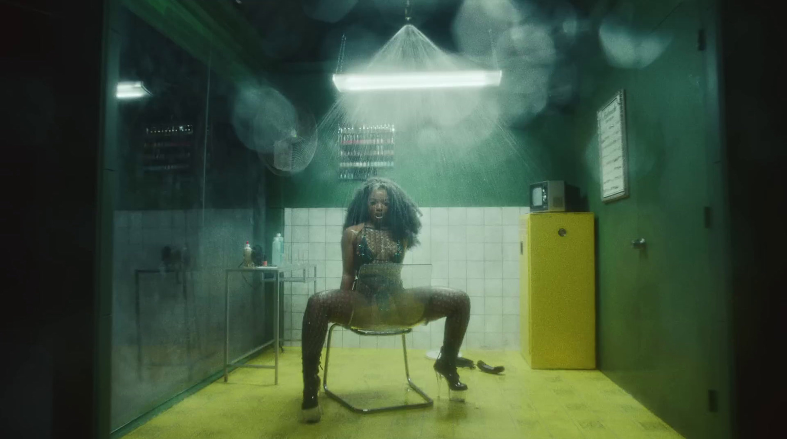 a woman sitting on a chair in a bathroom