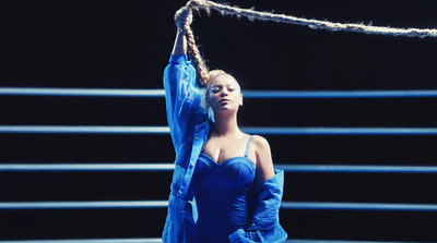 a woman in a blue dress holding a rope