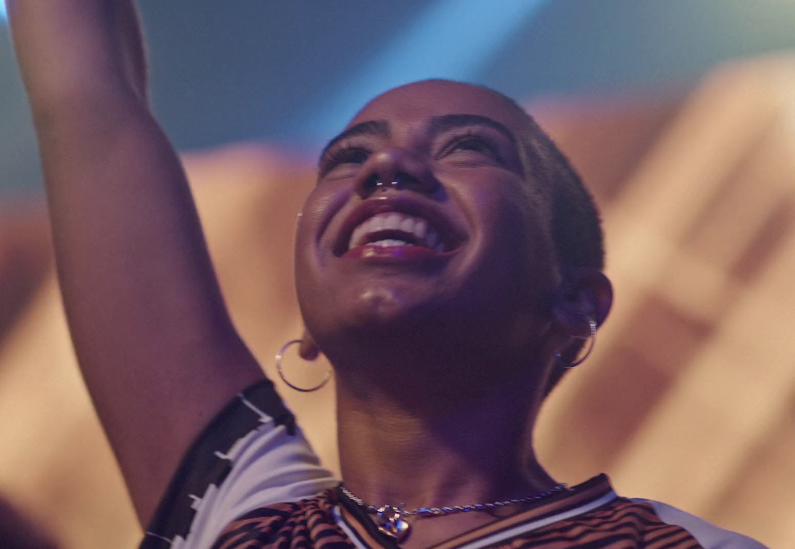 a woman holding a cell phone up in the air