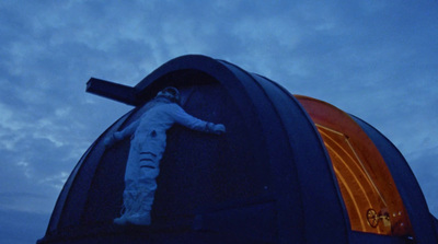 a person in a space suit hanging from the side of a building