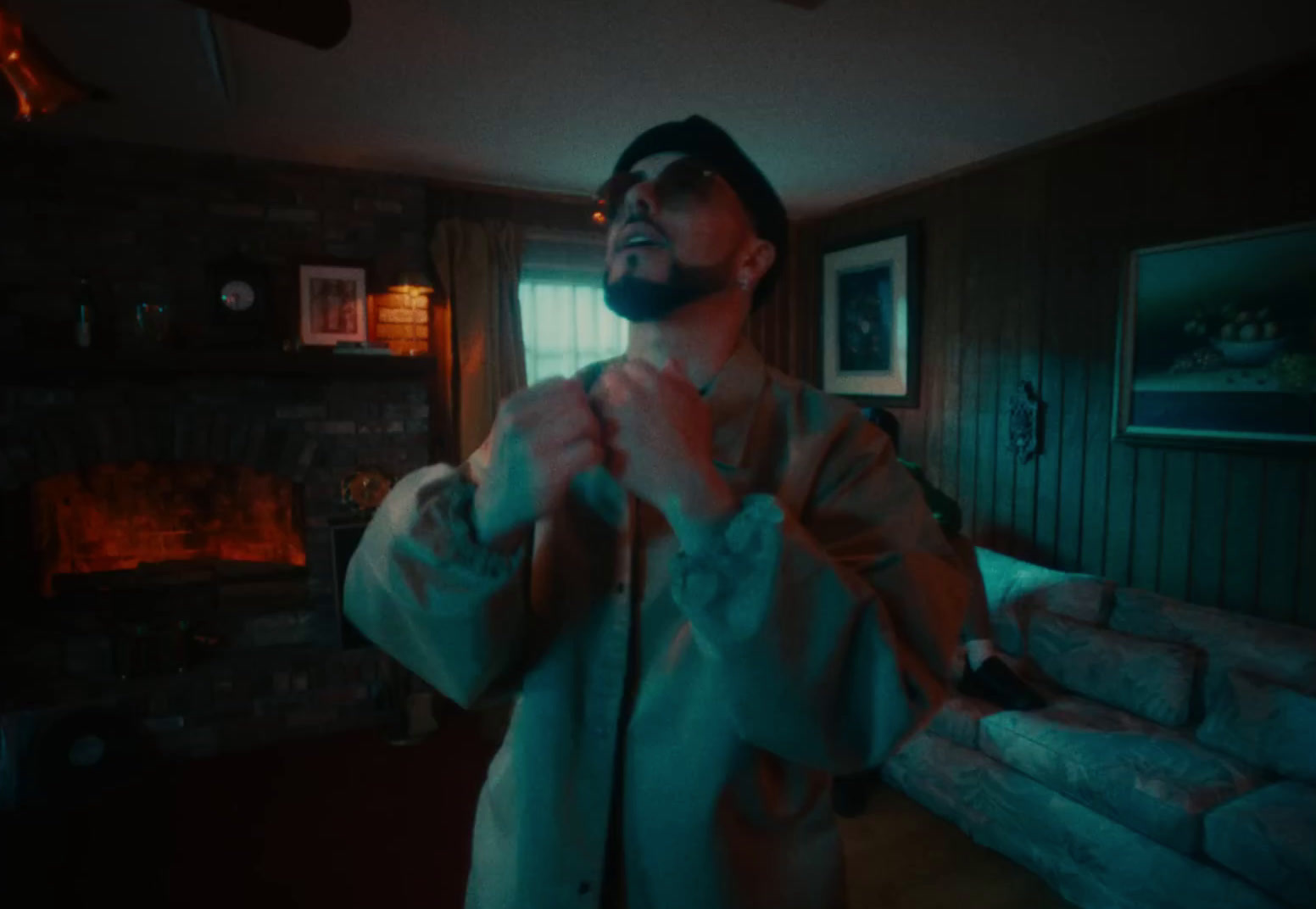 a man in a bathrobe standing in a living room