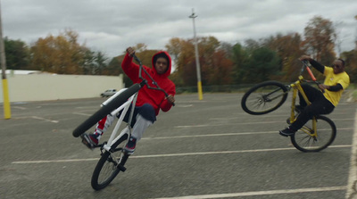 a person riding a bike in a parking lot