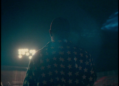 a man standing in front of a crowd at a concert