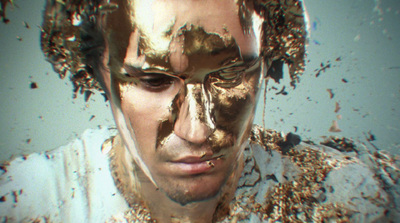 a man with gold paint all over his face