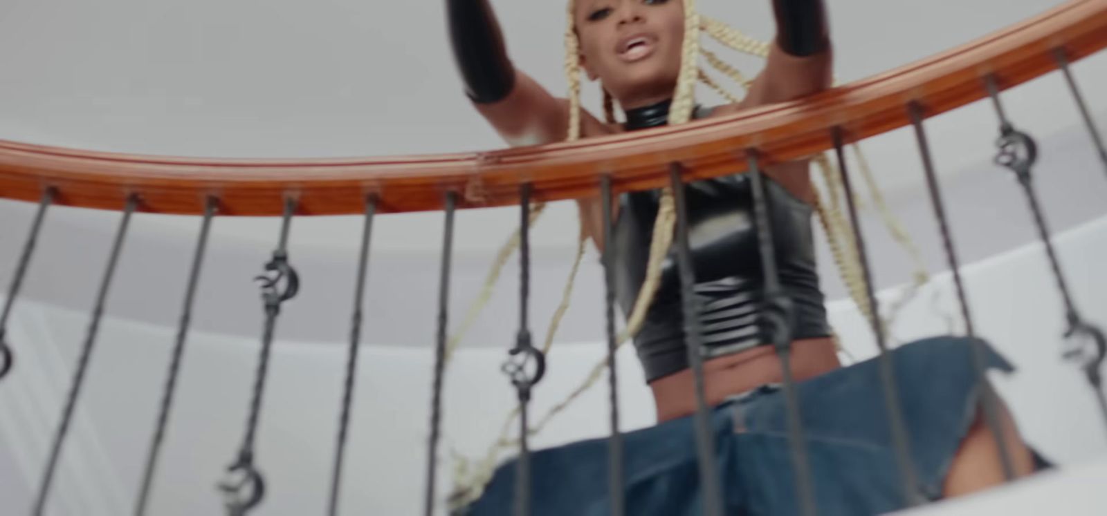 a woman standing on top of a wooden boat