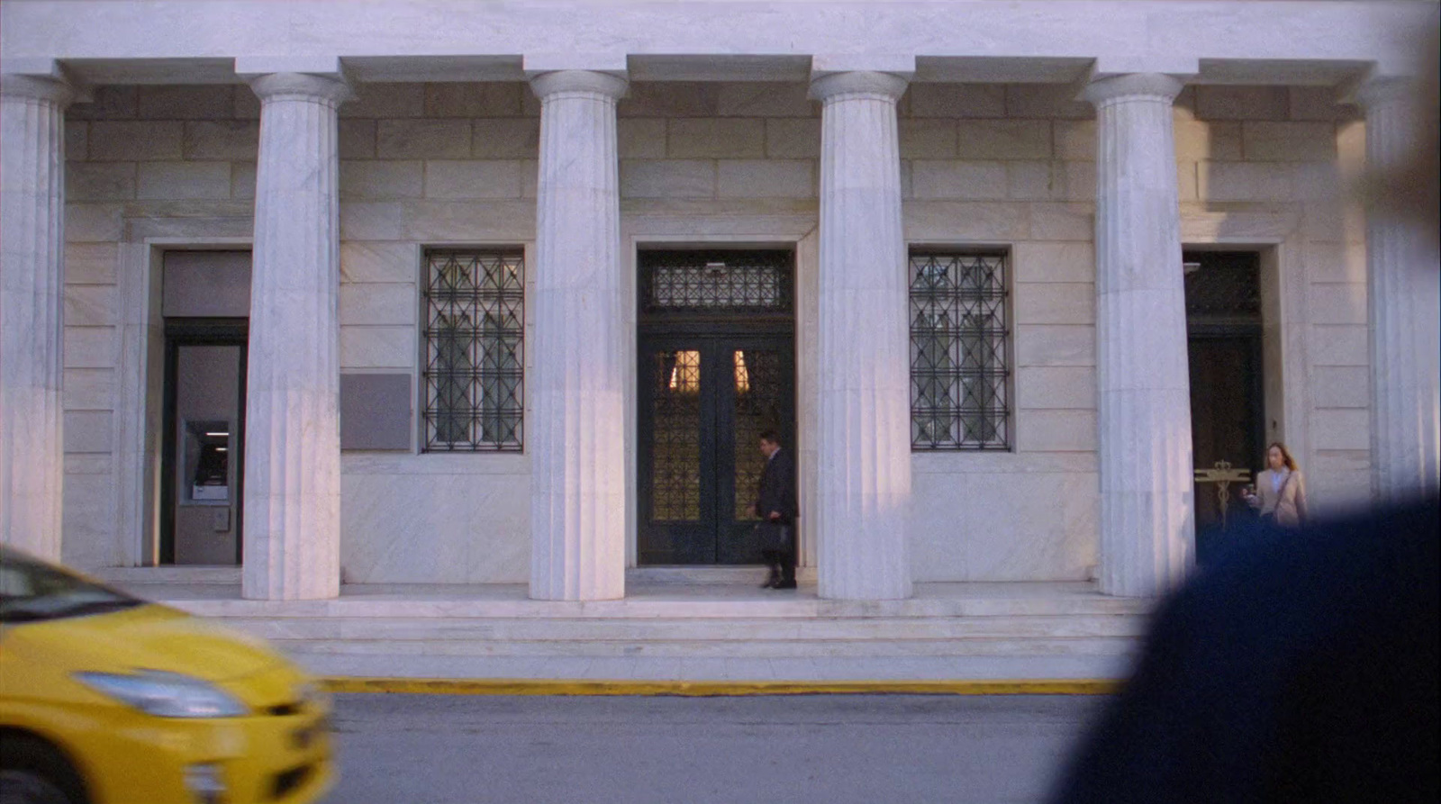 a yellow car is parked in front of a building