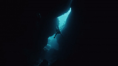 a person is diving in the dark water