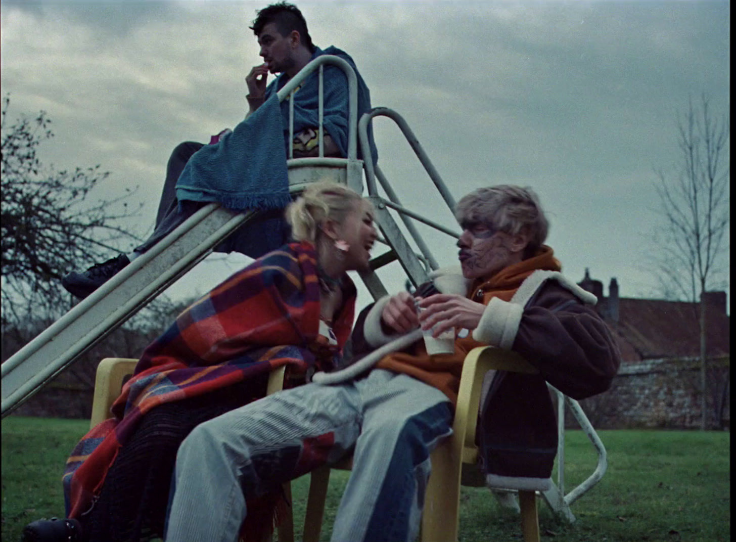 a man and a woman sitting on a chair in front of a slide