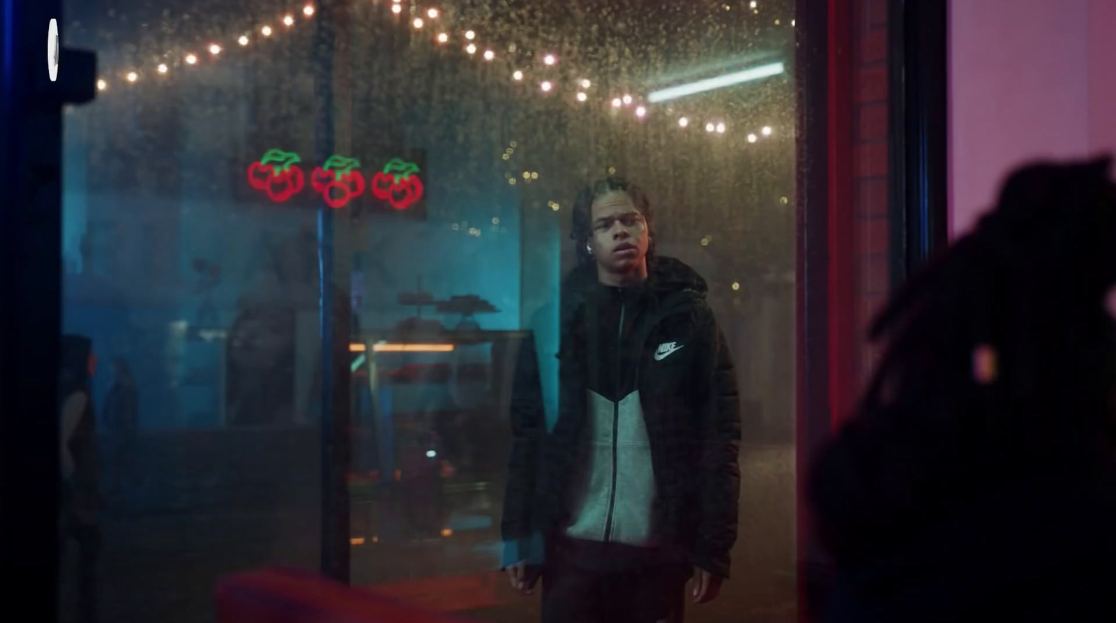 a man standing in front of a store window