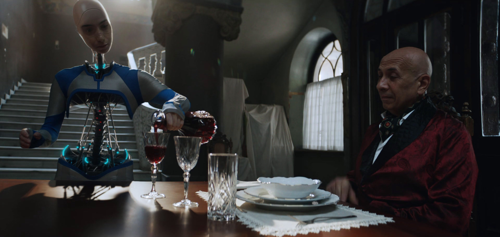 a man pouring a glass of wine to another man