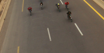 a group of people riding bikes down a street